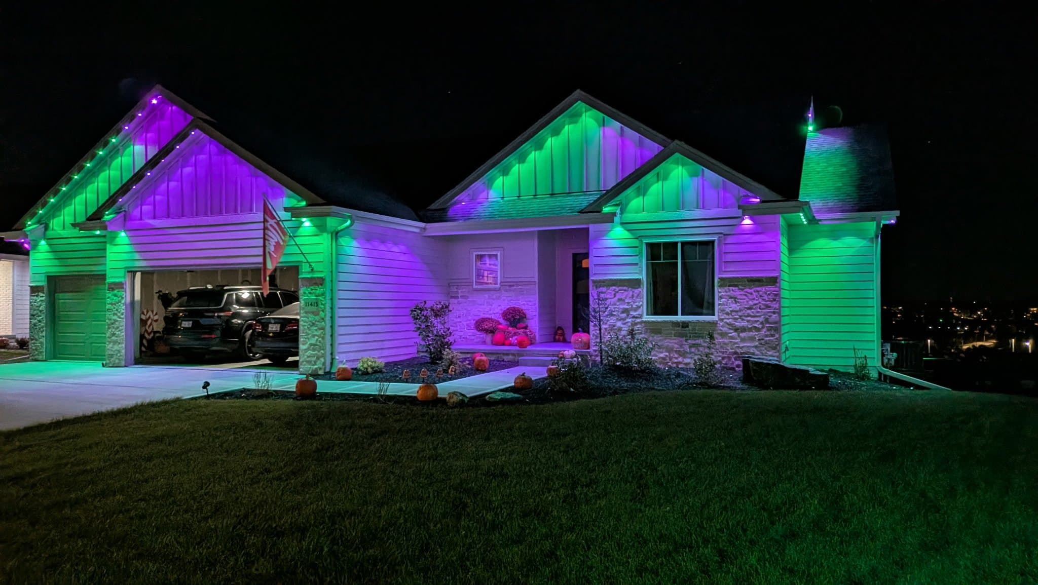 Ranch home lit in green and purple permanent lighting for fall